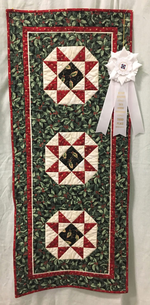 1011 “Christmas Table Runner” by Maggie Ball, 3rd Place Miscellaneous Category, 2018 Kitsap Quilt Show
